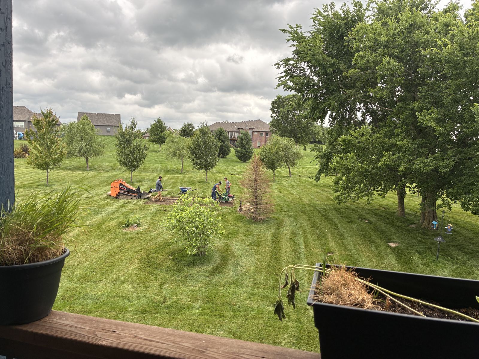 Raised Vegetable Garden — crew prepping the graded strip, viewed from the deck