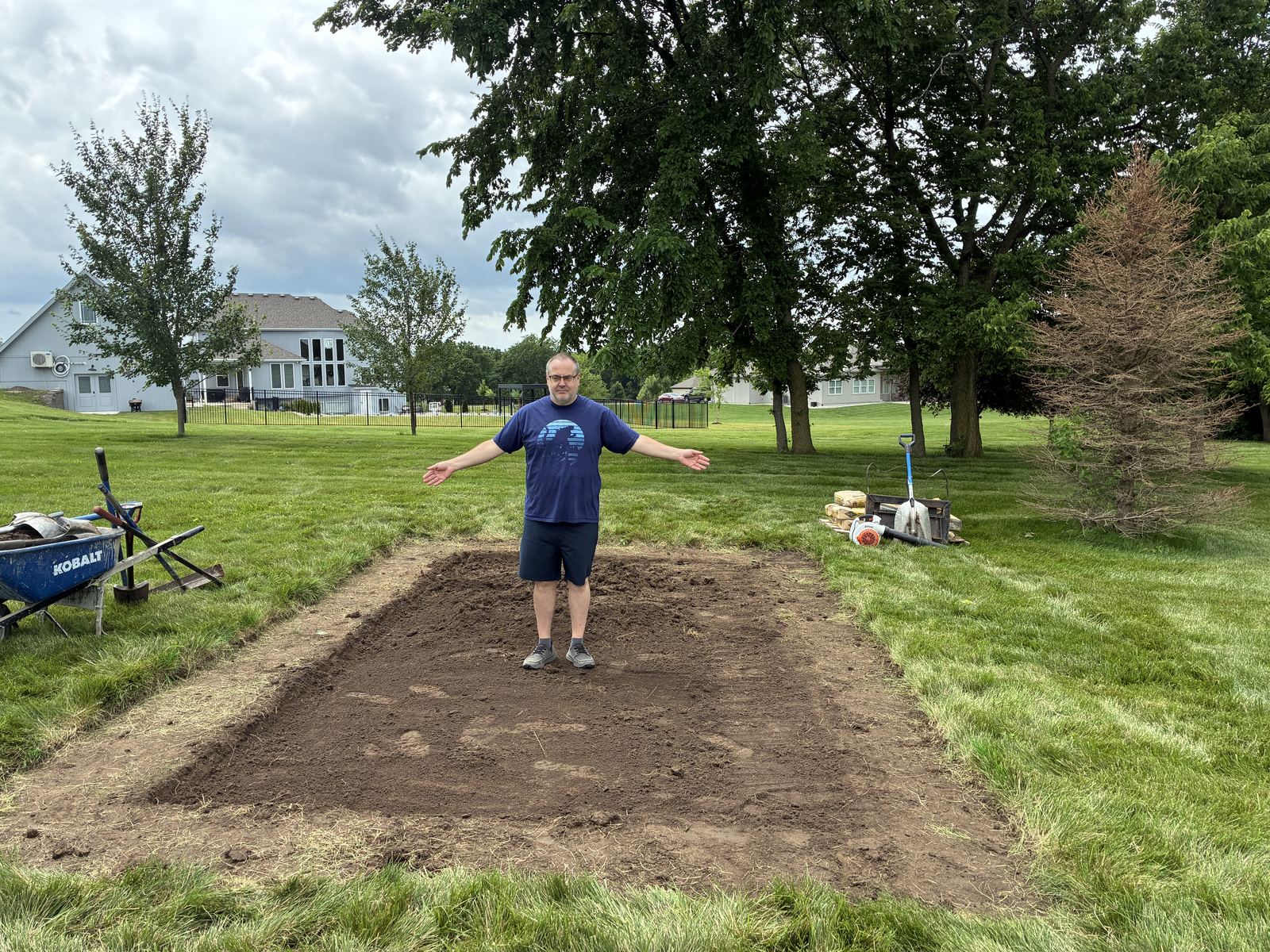 Raised Vegetable Garden — standing in the bare, leveled footprint before the kit arrived