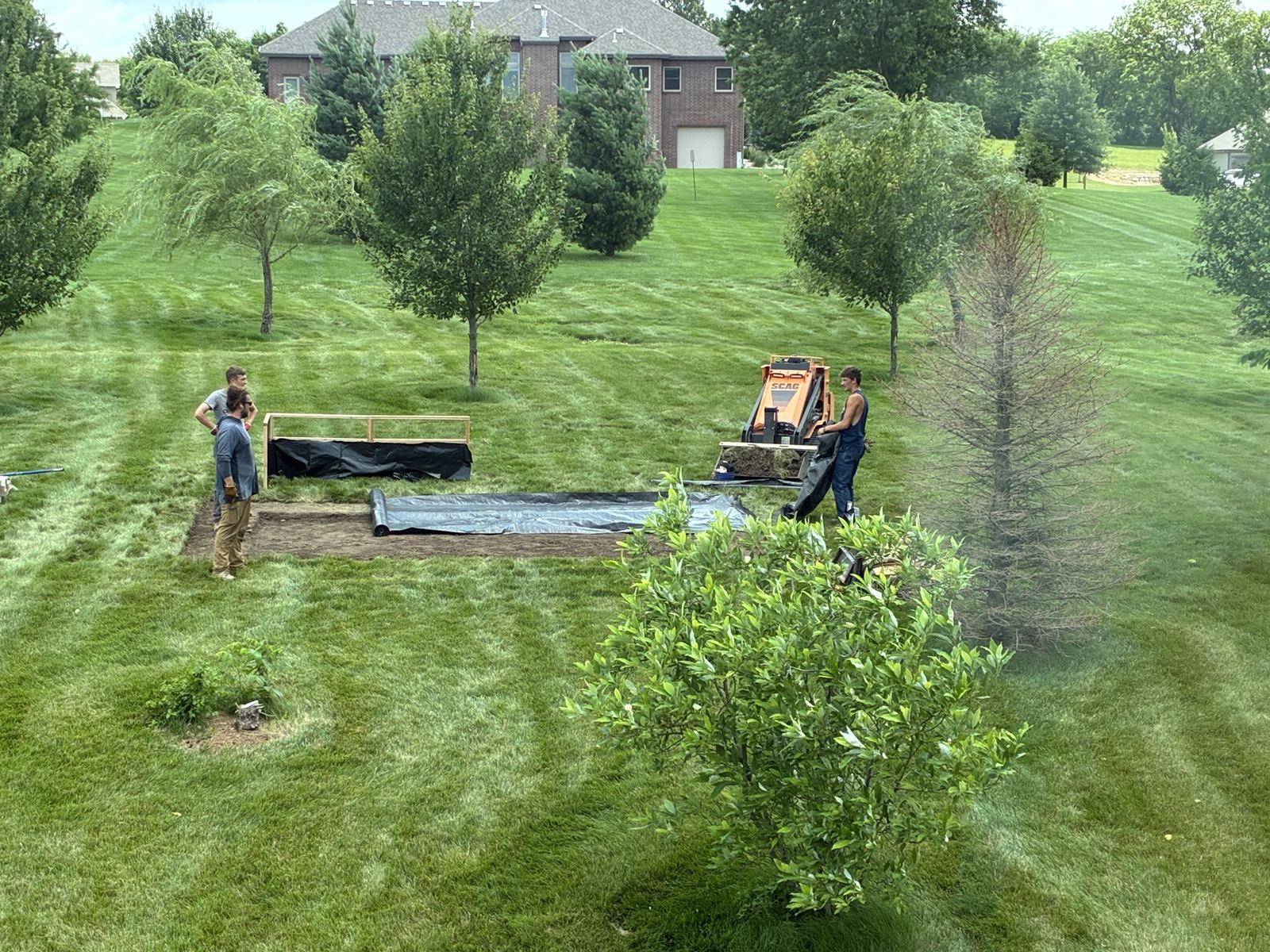 Raised Vegetable Garden — landscape fabric and the first frame boards going down