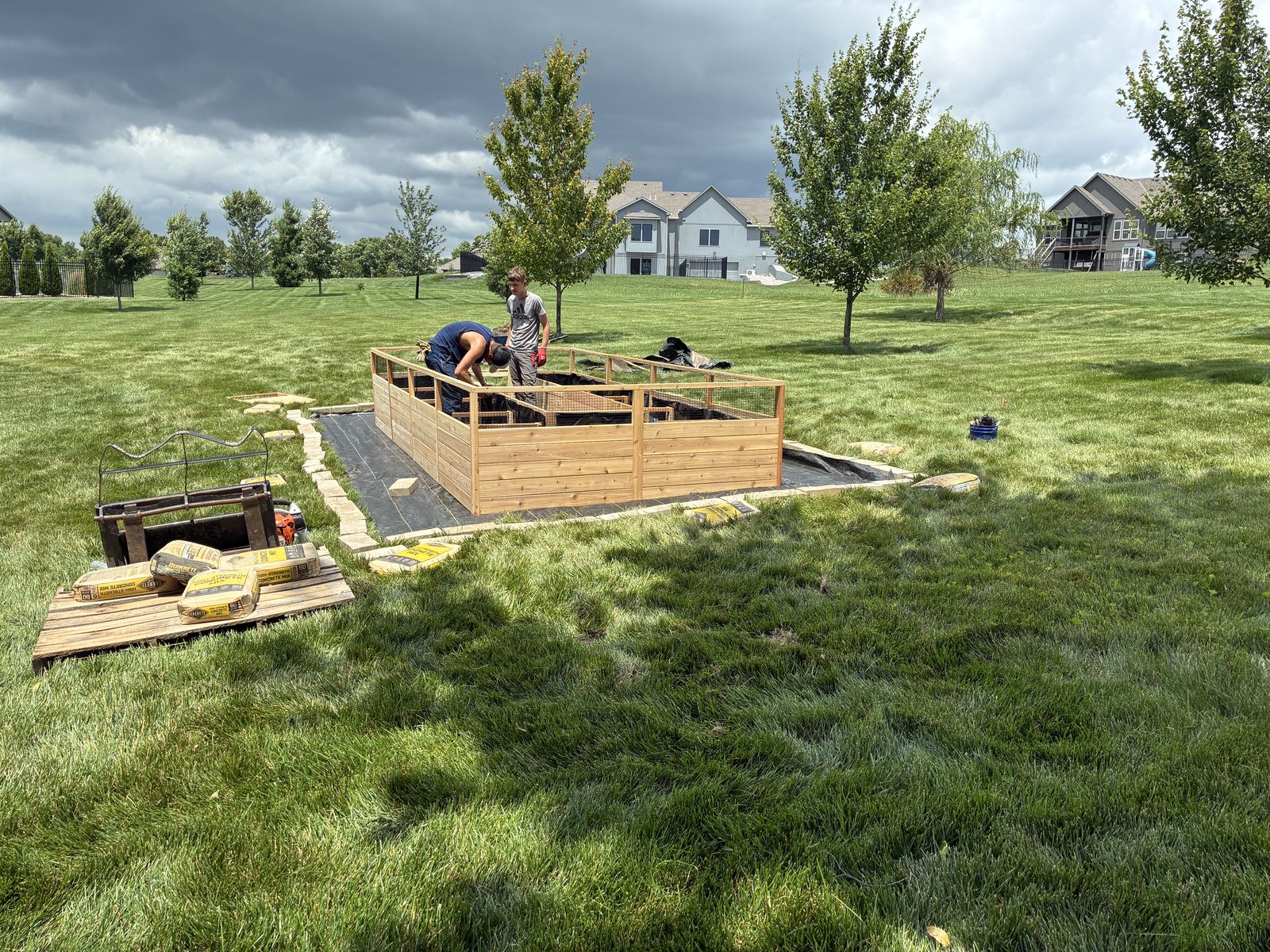 Raised Vegetable Garden — cedar walls going up over a paver and gravel base
