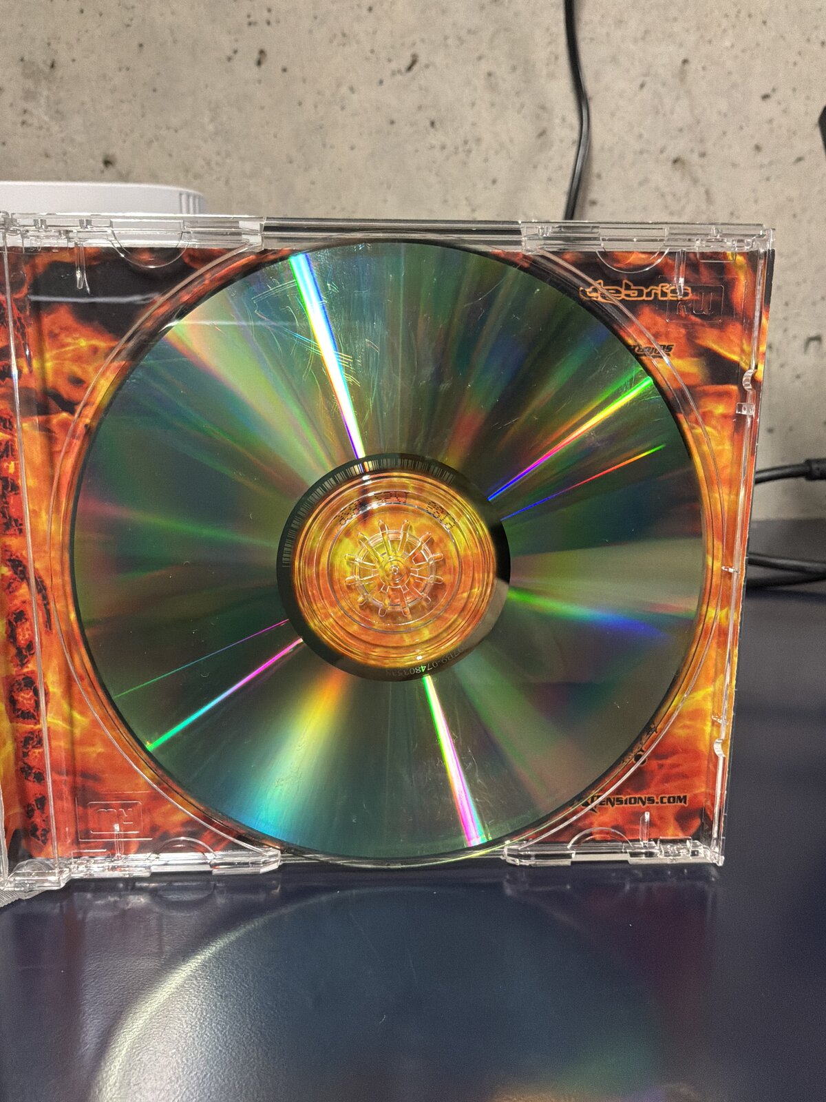 Anonymity by Debris — close-up of the disc surface catching the light